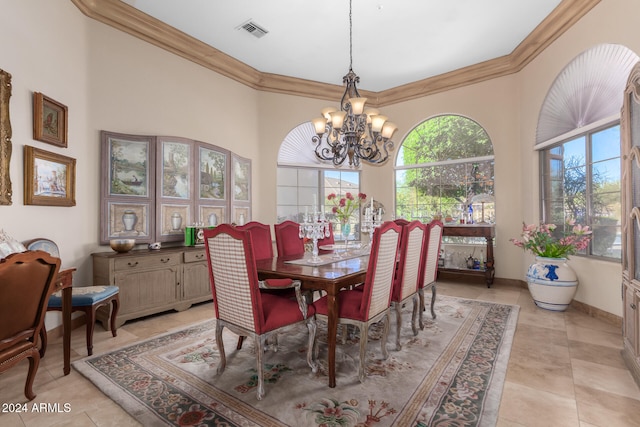 dining space with ornamental molding, light tile patterned flooring, and an inviting chandelier