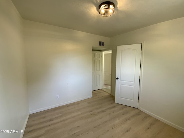 spare room with light hardwood / wood-style floors