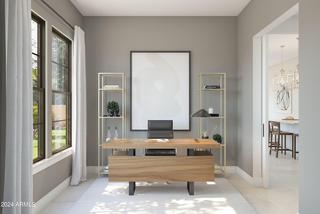 office space with tile patterned floors, baseboards, and an inviting chandelier