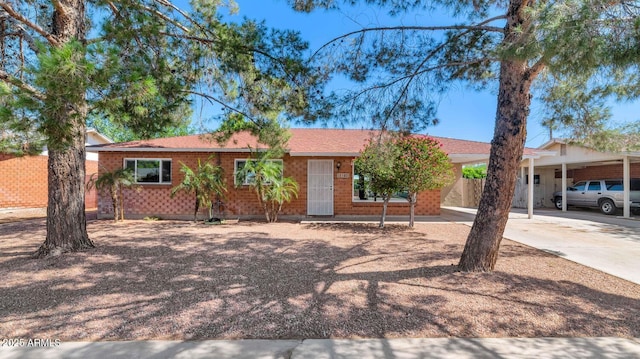 8140 E Mitchell Dr, Scottsdale, AZ 85251 - ranch-style house with driveway, a carport, and brick siding