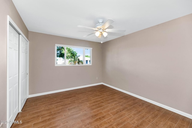 8140 E Mitchell Dr, Scottsdale, AZ 85251 - unfurnished bedroom featuring a closet, wood finished floors, and ceiling fan