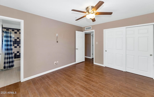 8140 E Mitchell Dr, Scottsdale, AZ 85251 - unfurnished bedroom with wood finished floors, a closet, and a ceiling fan