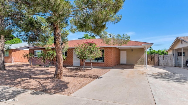 8140 E Mitchell Dr, Scottsdale, AZ 85251 - ranch-style house featuring driveway, an attached carport, brick siding, and a gate