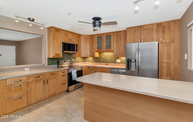 8140 E Mitchell Dr, Scottsdale, AZ 85251 - kitchen with stainless steel appliances, rail lighting, backsplash, and a ceiling fan