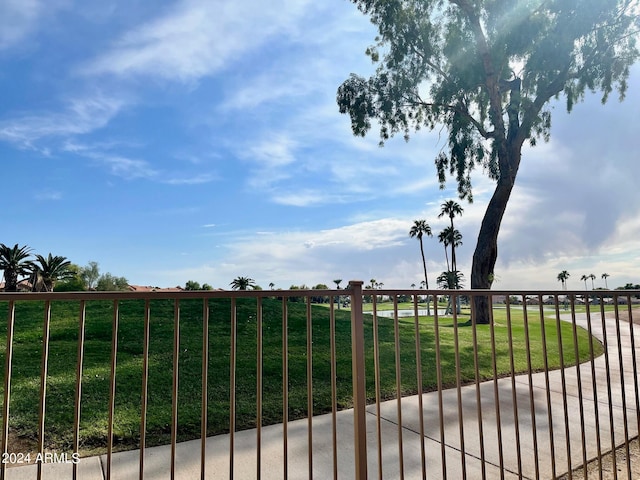 view of gate with a yard