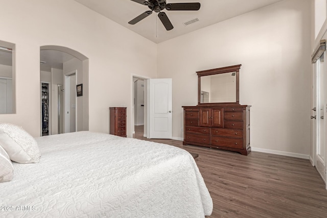 bedroom featuring ceiling fan, dark hardwood / wood-style flooring, a closet, and high vaulted ceiling