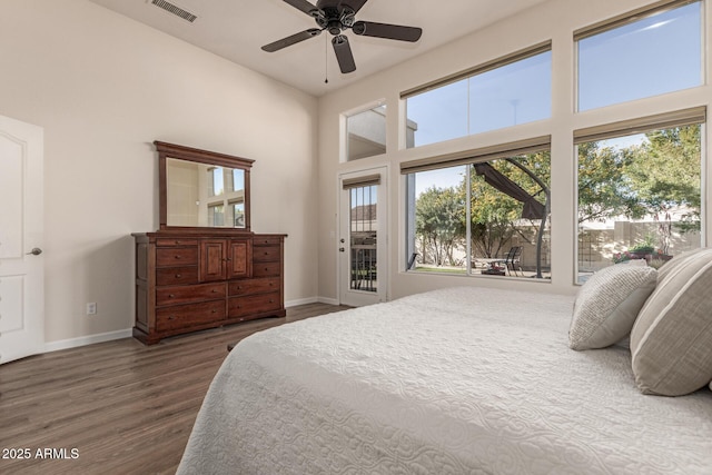 bedroom with access to exterior, ceiling fan, and dark wood-type flooring