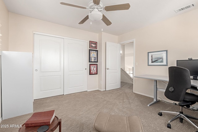 carpeted home office with ceiling fan