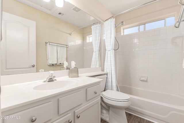 full bathroom with toilet, wood-type flooring, vanity, and shower / bath combo