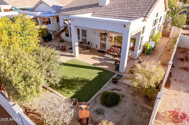 back of property featuring a patio area and ceiling fan