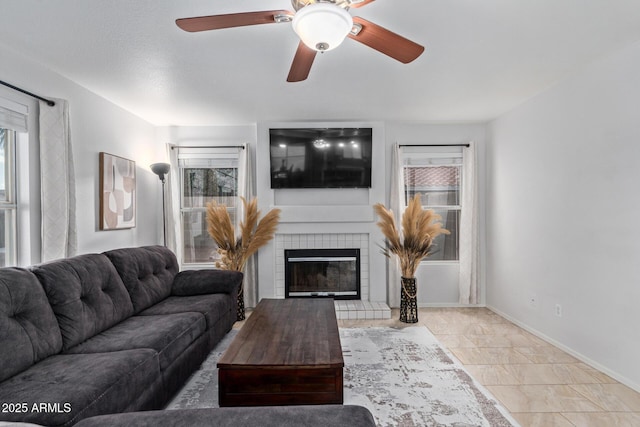4049 E Arbor Ave, Mesa, AZ 85206 - living area featuring plenty of natural light, a tile fireplace, baseboards, and a ceiling fan