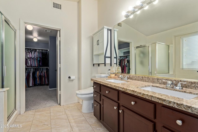 4049 E Arbor Ave, Mesa, AZ 85206 - full bathroom featuring a spacious closet, double vanity, a shower stall, and toilet