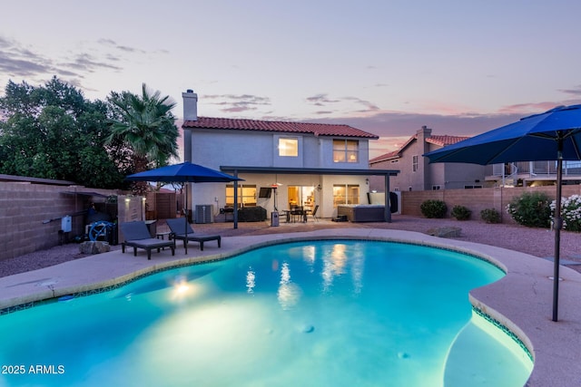 4049 E Arbor Ave, Mesa, AZ 85206 - pool at dusk featuring a patio area, a fenced backyard, and central air condition unit