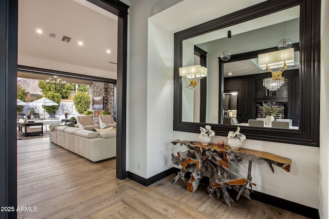 hallway with a chandelier