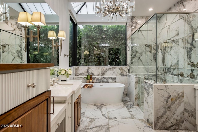 bathroom with vanity, separate shower and tub, tile walls, and a notable chandelier