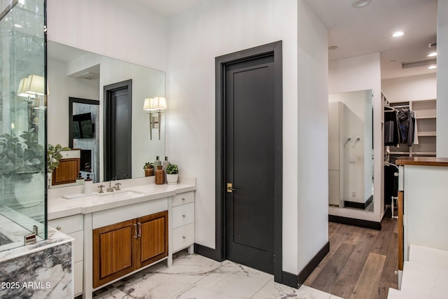 bathroom featuring vanity and a shower