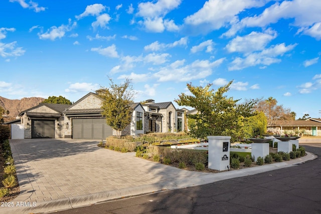 obstructed view of property with a garage and a mountain view