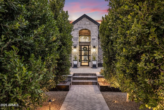 view of exterior entry at dusk