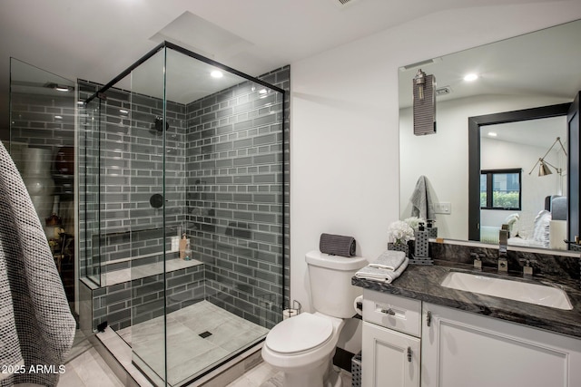 bathroom featuring vanity, toilet, and walk in shower