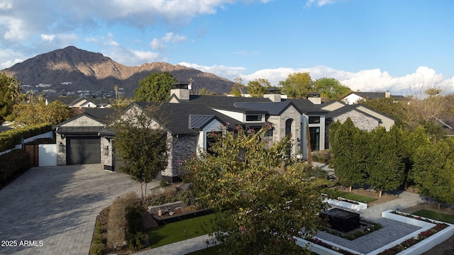 view of front facade with a garage and a mountain view