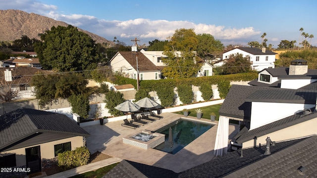 view of patio / terrace with a mountain view and an outdoor fire pit