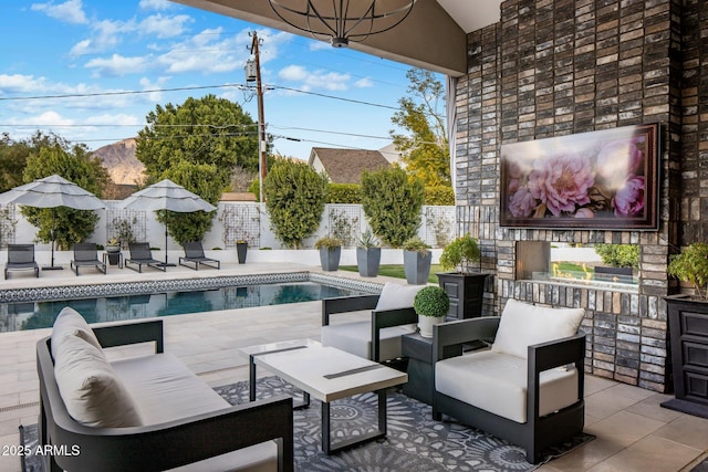 view of patio / terrace with a fenced in pool and an outdoor hangout area