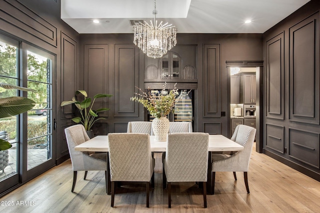 dining area featuring an inviting chandelier and light hardwood / wood-style floors