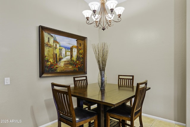 dining space with light tile patterned floors, a chandelier, and baseboards