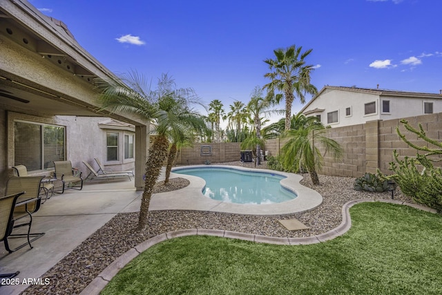 view of swimming pool with a lawn, a patio, a fenced in pool, and a fenced backyard