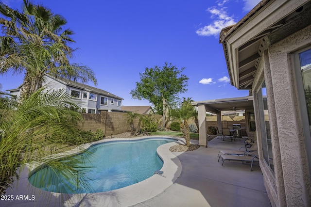 view of swimming pool featuring a fenced in pool, ceiling fan, a patio area, and a fenced backyard