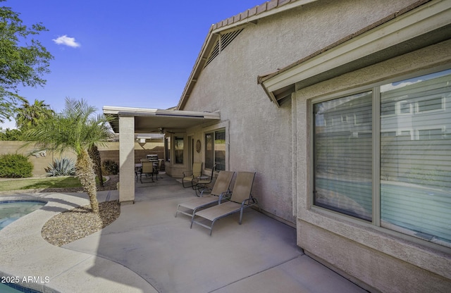 view of patio / terrace featuring fence, ceiling fan, and a fenced in pool