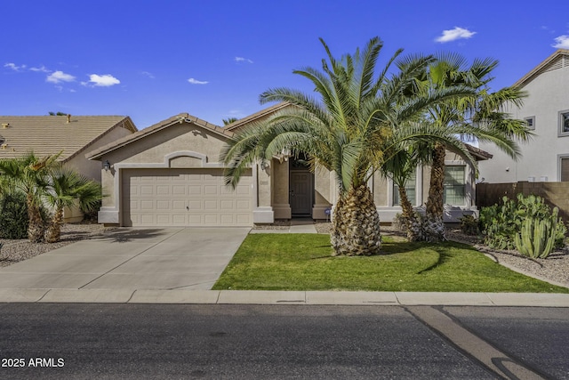 view of front of property with stucco siding, fence, a garage, a front yard, and concrete driveway