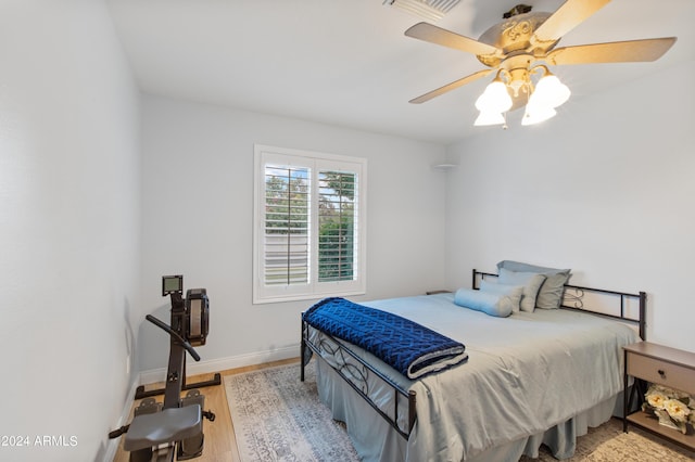 bedroom with light hardwood / wood-style flooring and ceiling fan