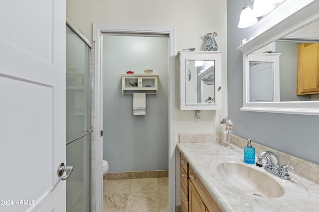 bathroom with vanity, toilet, and walk in shower