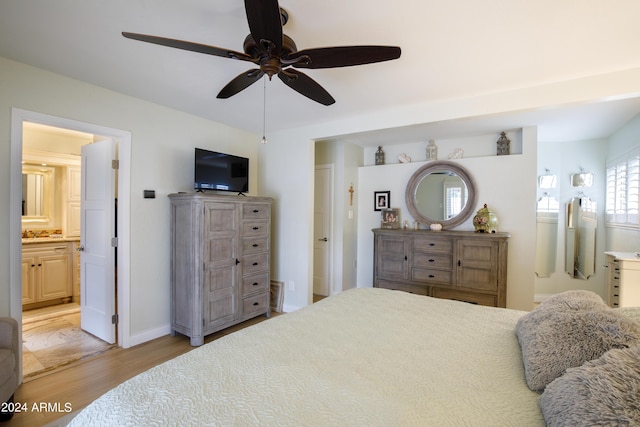 bedroom with connected bathroom, light hardwood / wood-style floors, and ceiling fan