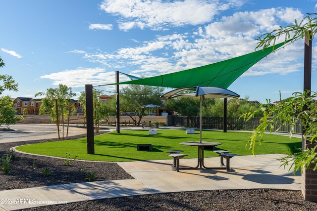 view of playground with a lawn and fence