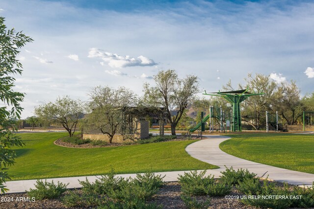 surrounding community featuring playground community and a lawn