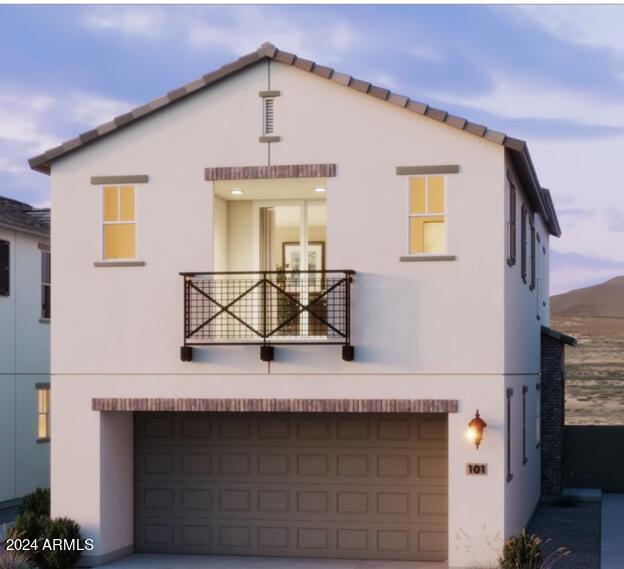 view of front of home featuring stucco siding, a balcony, concrete driveway, and an attached garage