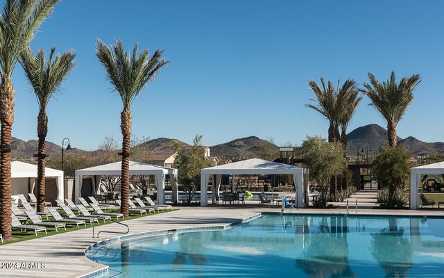 view of pool with a gazebo and a mountain view