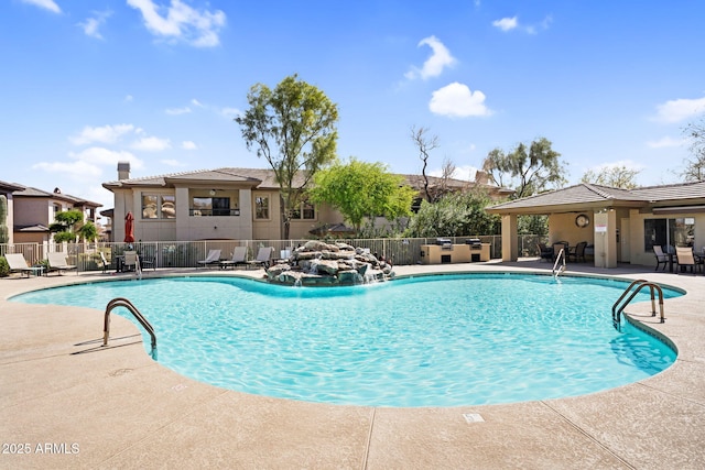 pool with fence and a patio