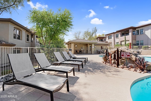 exterior space featuring fence and a community pool