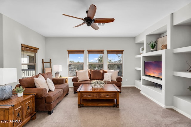 living room with baseboards, ceiling fan, carpet flooring, and built in features