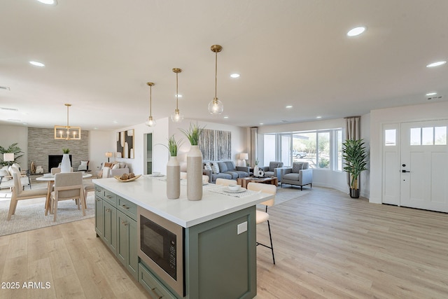 kitchen featuring open floor plan, recessed lighting, and built in microwave