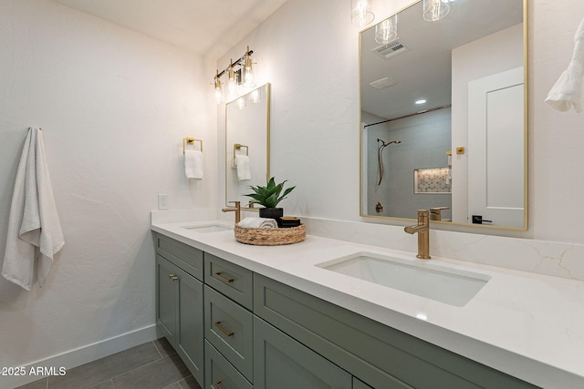 full bath featuring double vanity, visible vents, a sink, and walk in shower