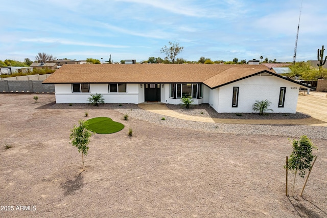 ranch-style house with fence