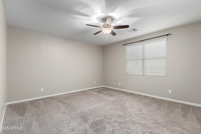 spare room featuring ceiling fan and carpet