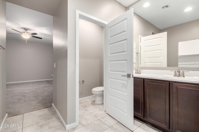 bathroom featuring vanity, tile patterned floors, ceiling fan, and toilet