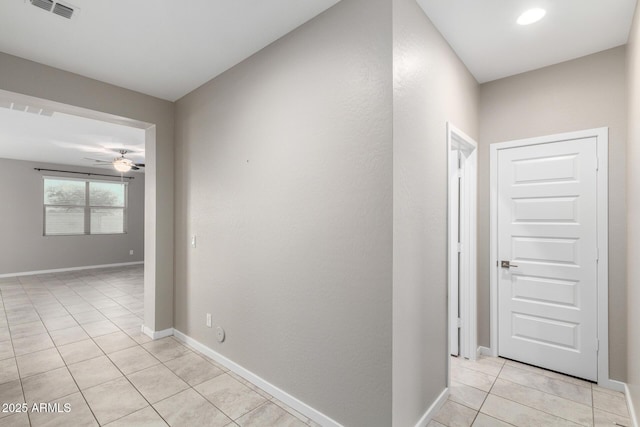 corridor featuring light tile patterned floors