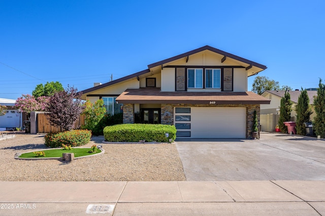 8419 E Stella Ln, Scottsdale, AZ 85250 - view of front facade with stone siding, fence, driveway, and an attached garage