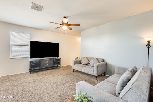 carpeted living room with ceiling fan